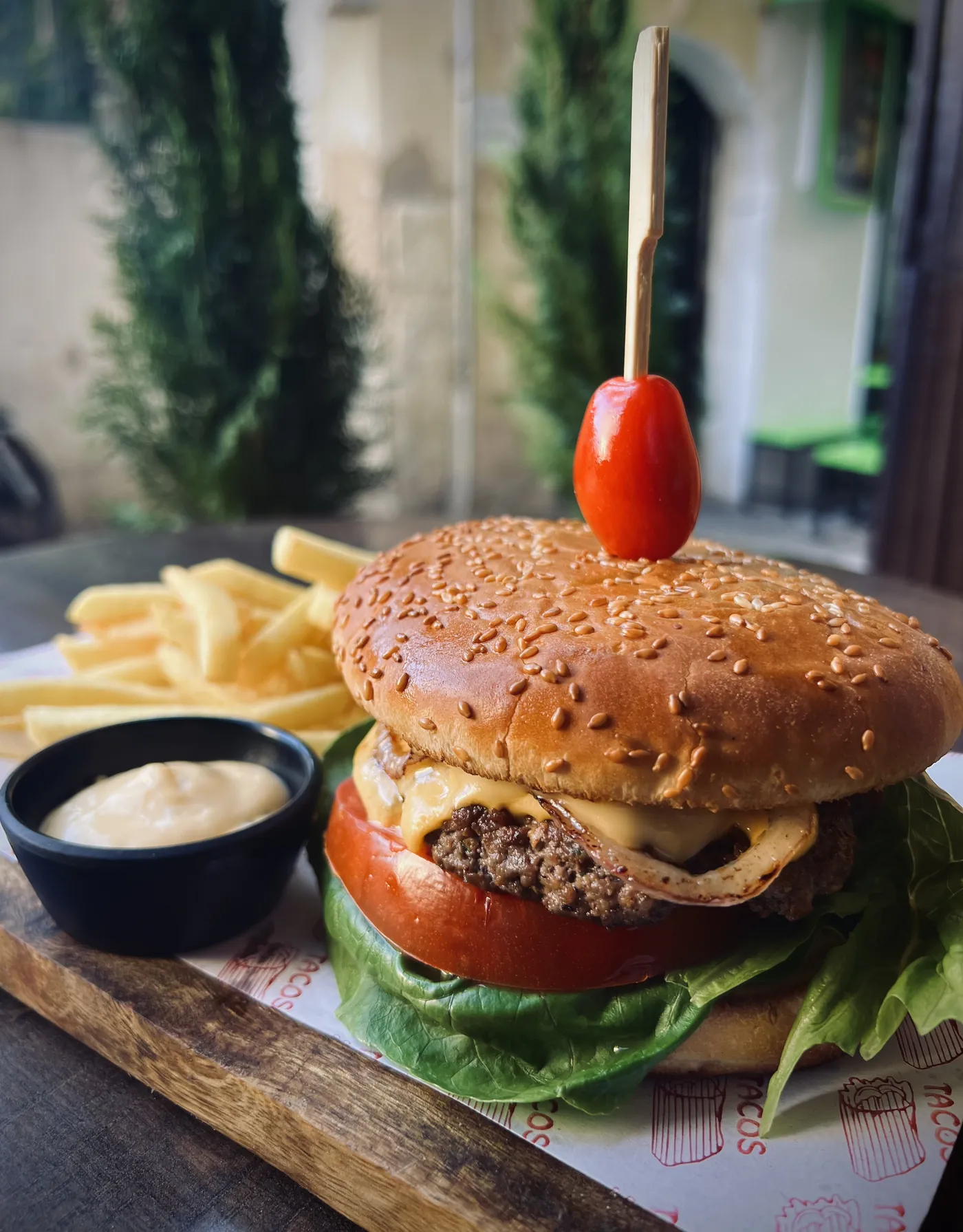 A cheeseburger with fries and sauce at Culture Box
