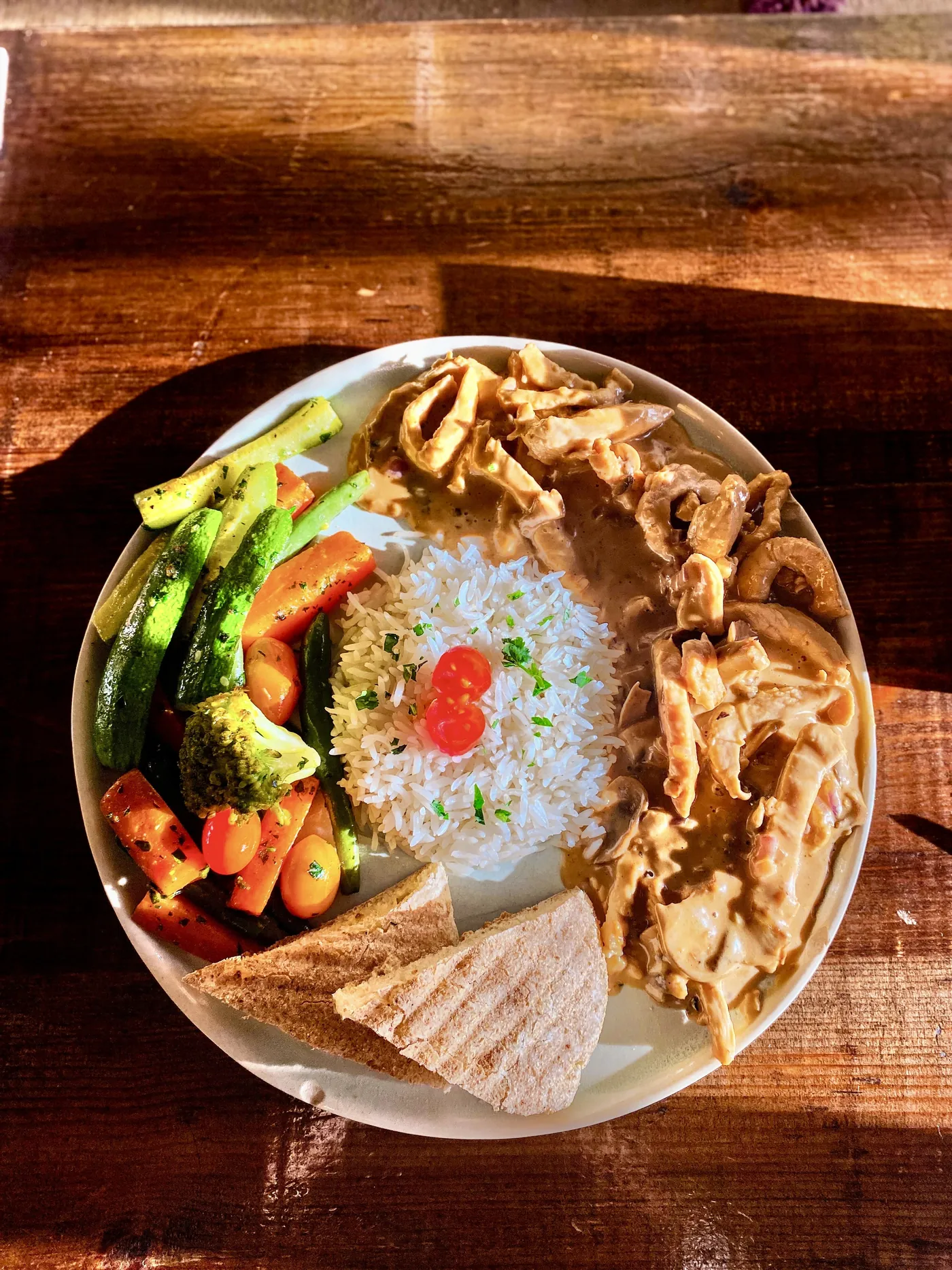 Rice with fried chicken strips and green vegetables at Culture Box