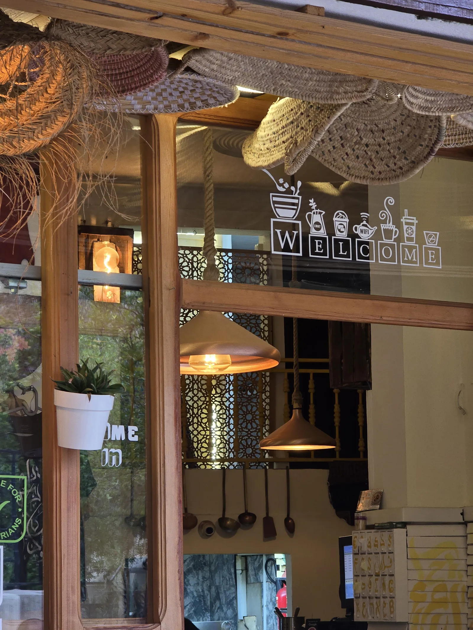 The WELCOME sign above the Culture Box doorway, framed by baskets and plants